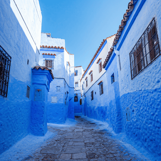 Winding cobblestone street in Chefchaouen painted in vibrant blues